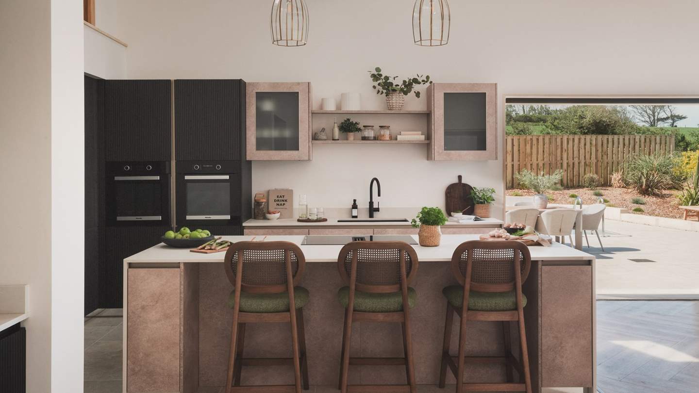 Beyond the dining area lies a sleek kitchen, fully equipped and designed for easy entertaining