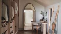 A dedicated dressing room proposes an elegant space to prepare for the day