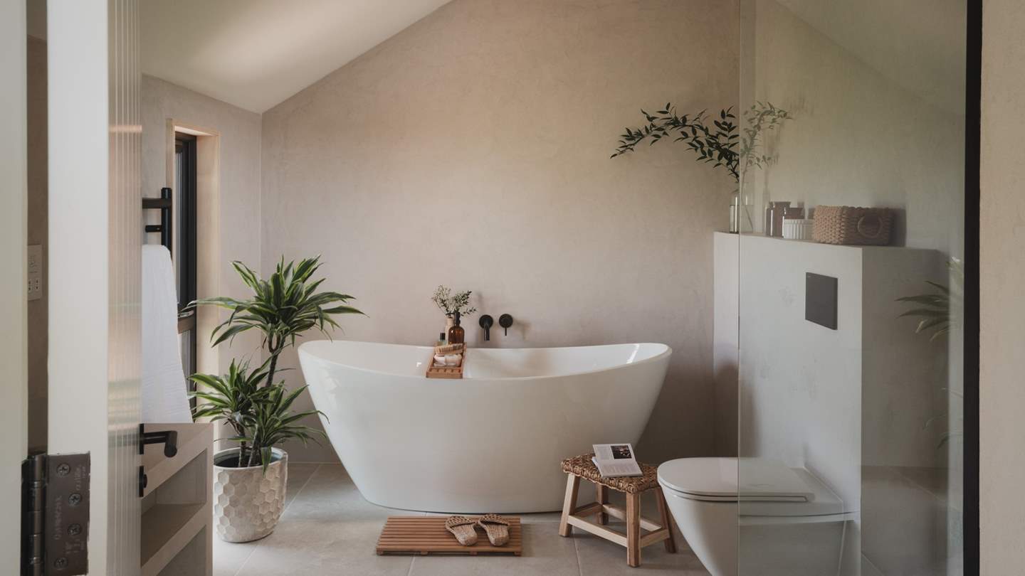 The ensuite bathroom welcomes calming self-care rituals