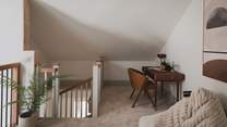 On the mezzanine, a cosy snug provides a restful spot to catch up on emails