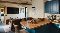 Promising wooden worktops and teal-toned shaker cabinetry is the rustic country kitchen