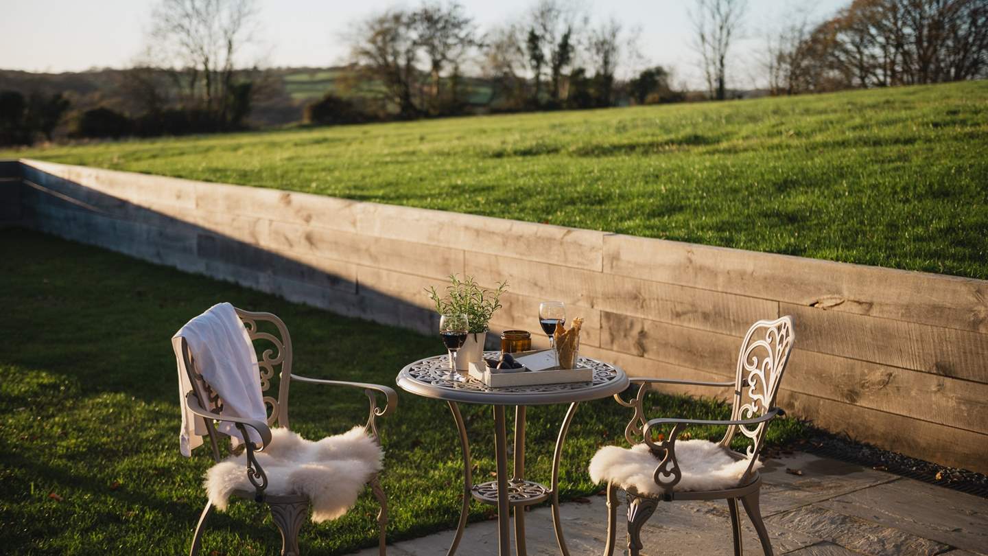 For the lovers of alfresco suppers, a wrought iron bistro table for two awaits on the stone patio