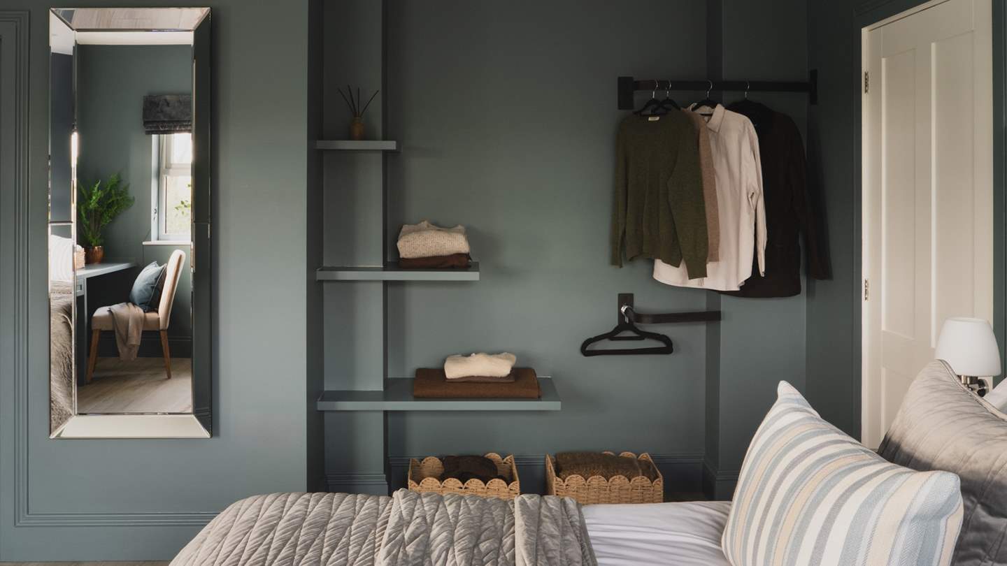 A dressing table, open shelving and a hanging rail await to store your garments