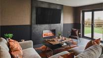 Discover the cosy seating area with an electric fire and a Smart TV