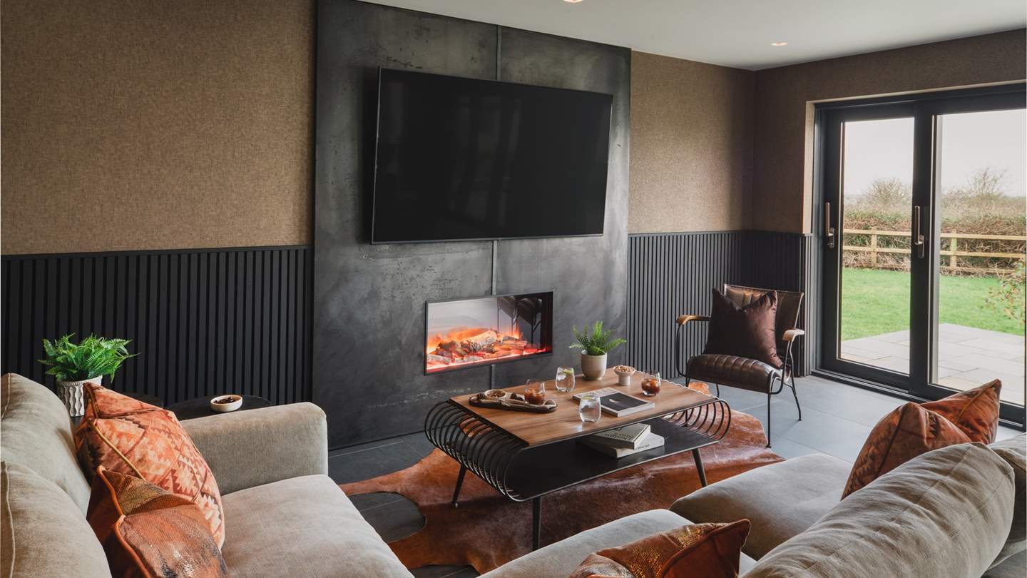 Discover the cosy seating area with an electric fire and a Smart TV