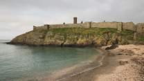 Take a stroll across Fenella beach, settled below Peel Castle 