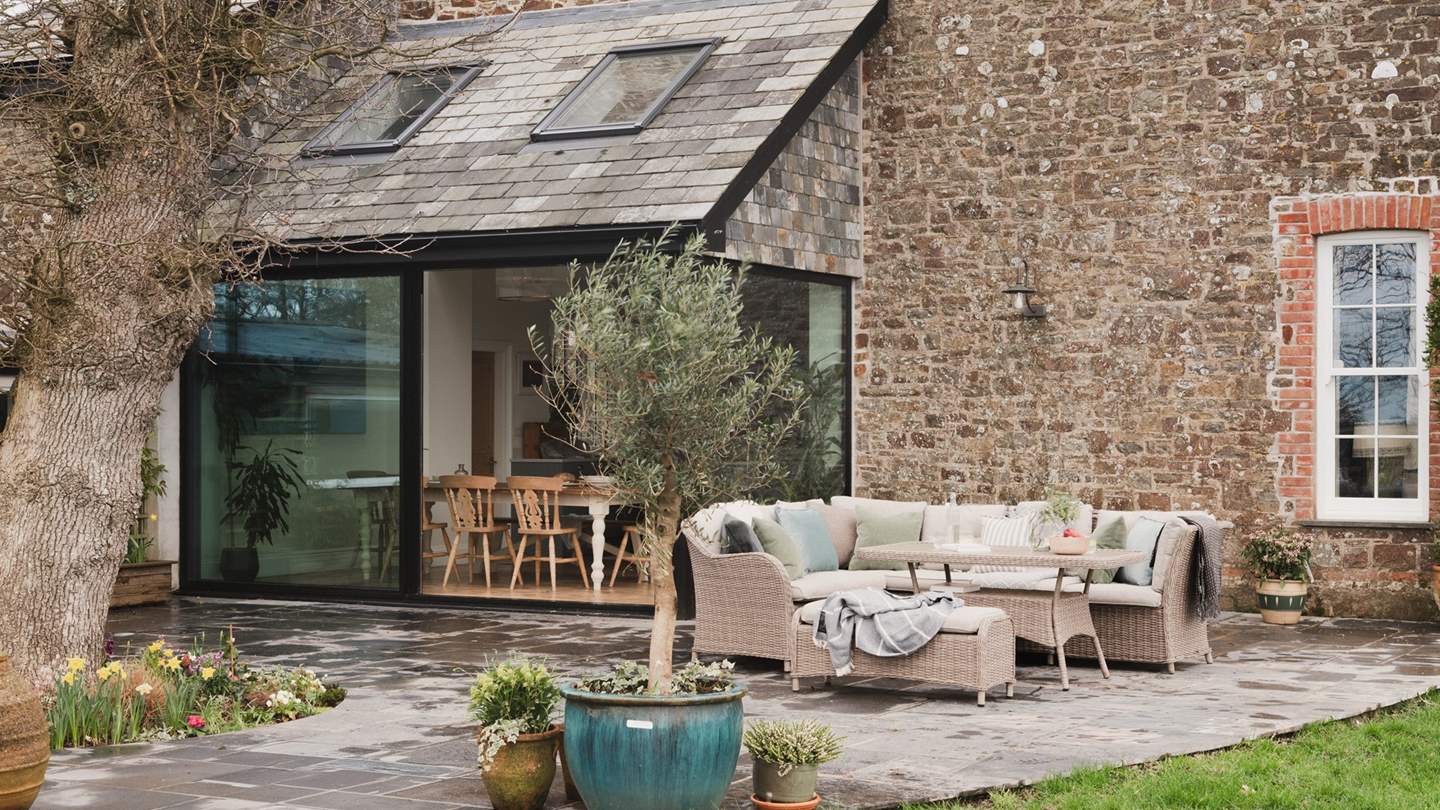 A sun dappled patio sits beyond the dining space