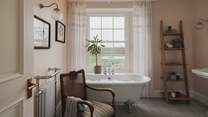 Step into the first family bathroom, wrapped in powder pink walls and home to a large freestanding bath 