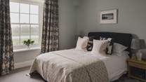 The third bedroom welcomes heavenly slumber with a king-size bed dressed in cloud-soft linens 