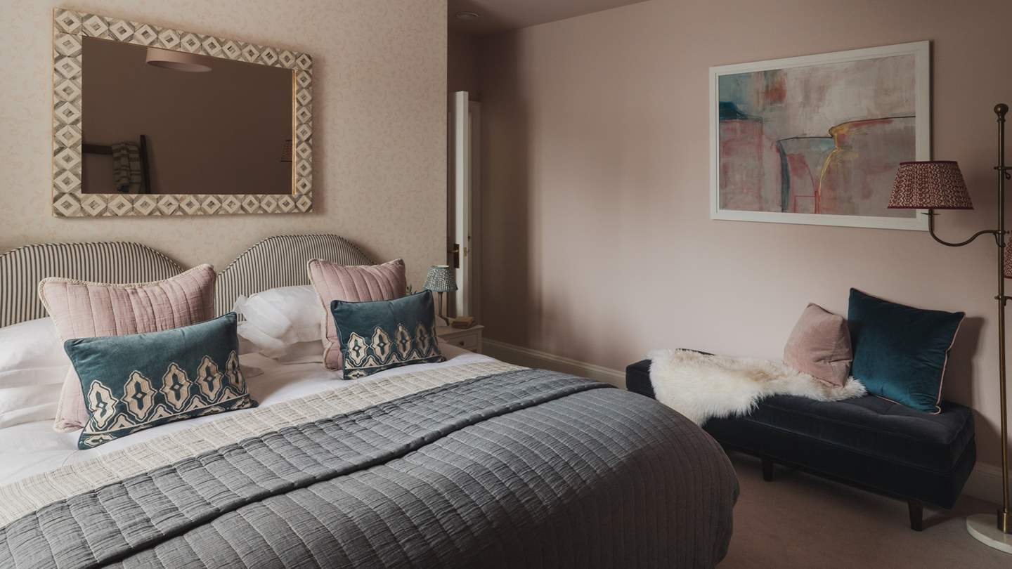 A Pooky lamp sits elegantly beside a sumptuous chaise