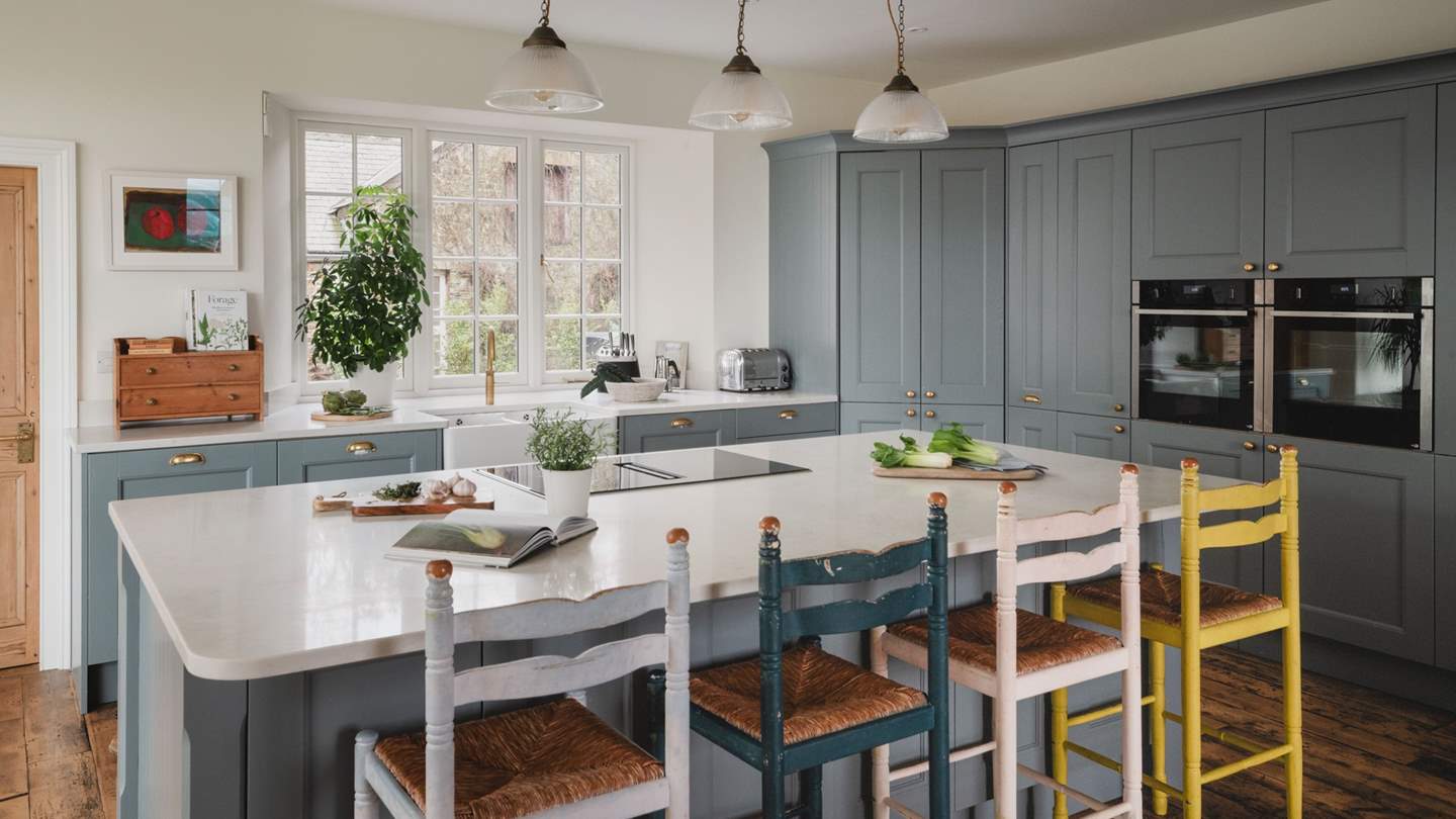 A kitchen island with a vented hob encourages relaxed conversation as cooking unfolds