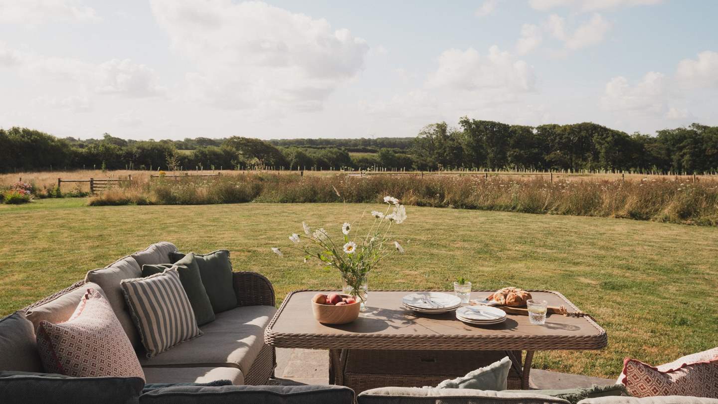 A large outdoor table sets the scene for leisurely meals alfresco