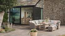 A sun dappled patio sits beyond the dining space