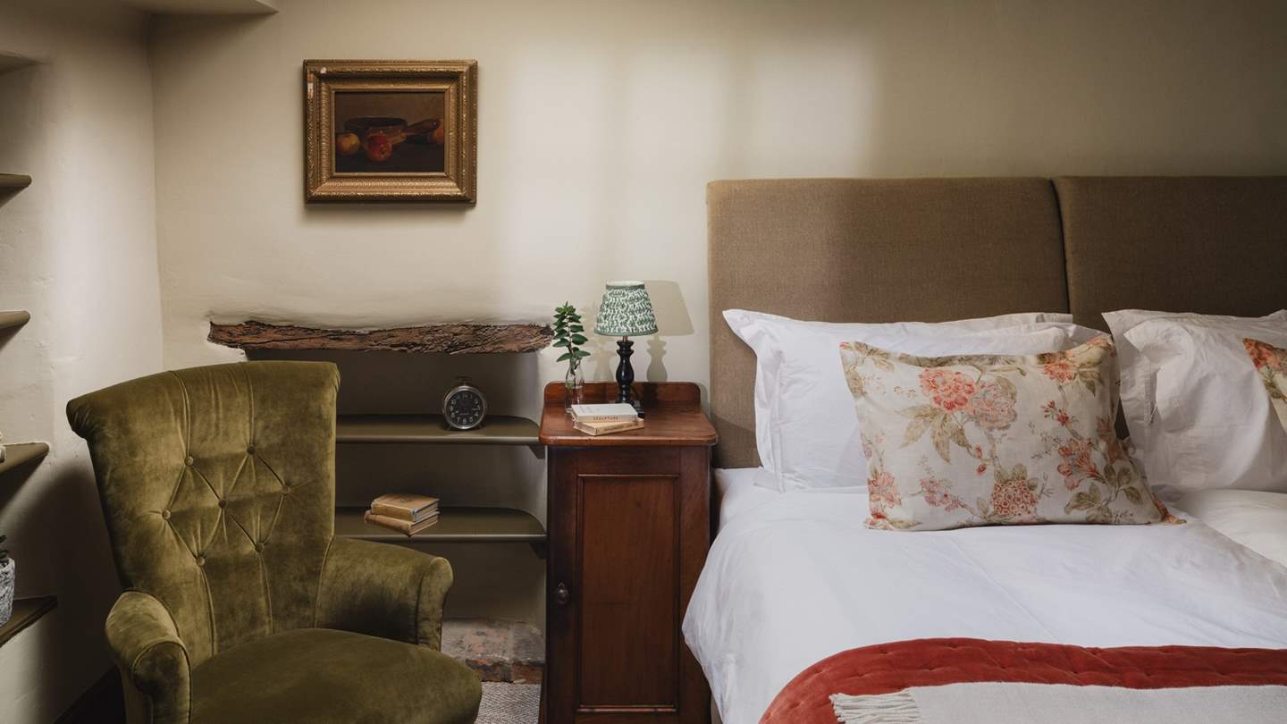 A super-king size bed awaits, alongside an occasional armchair for those seeking a spot to retreat with a novel