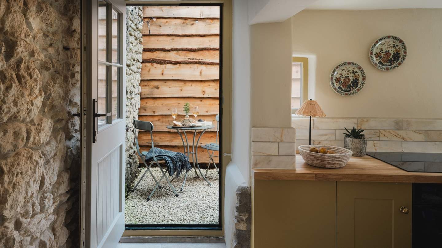 Flowing seamlessly from the kitchen to the outdoors is the small courtyard garden 