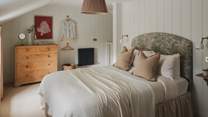 Wood-panelling and Nkuku soft furnishings promises endless rustic charm