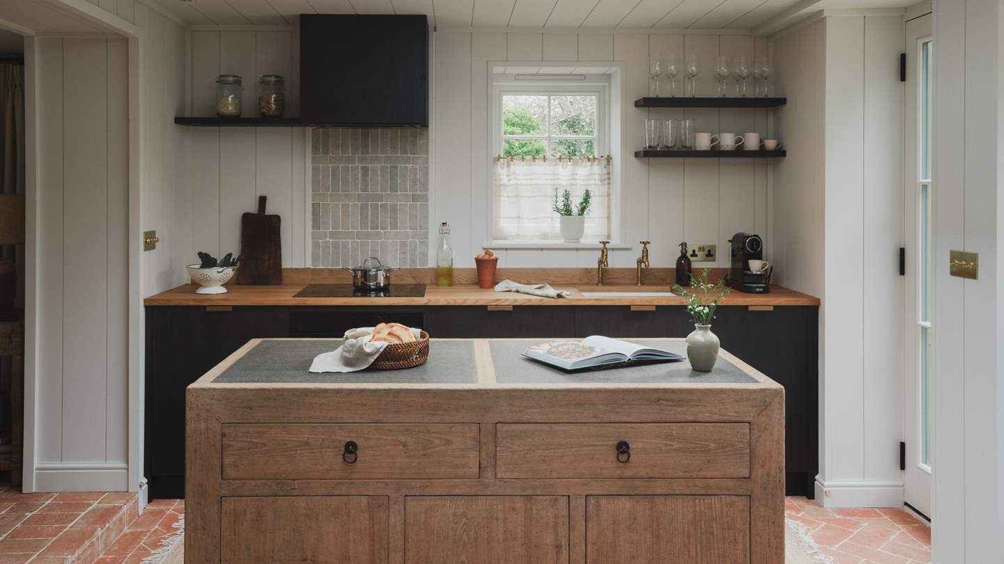 Anchoring the space is a unique wooden island sourced in the Netherland - the perfect spot to prep