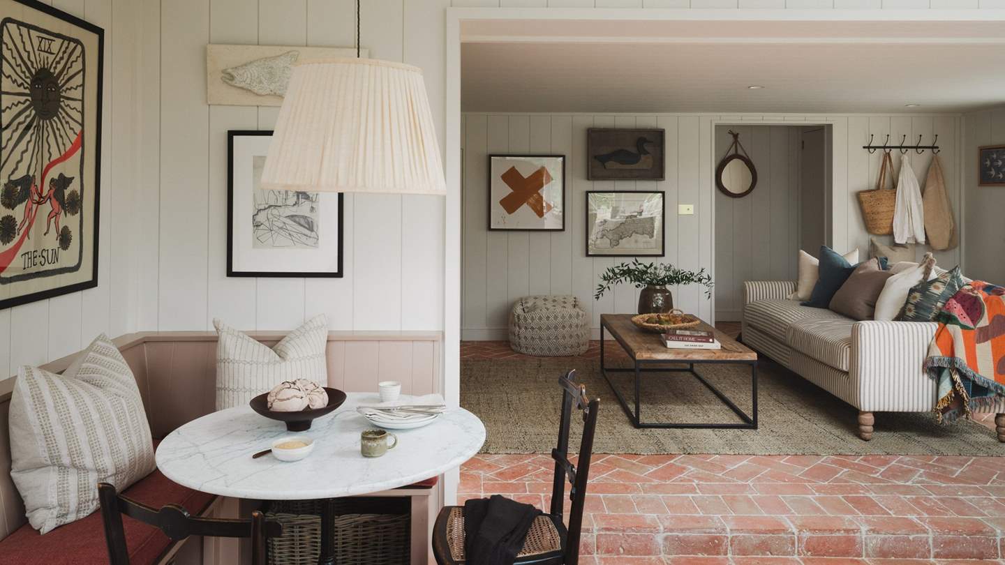 A marble topped table and pretty linen curtains promise a romantic spot to dine