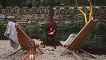 A rustic chiminea awaits for ambient nights beneath the stars