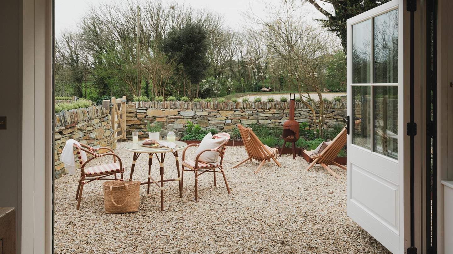 A dream for the lovers of indoor‑outdoor living, pretty bi-fold doors open onto a charming cottage garden