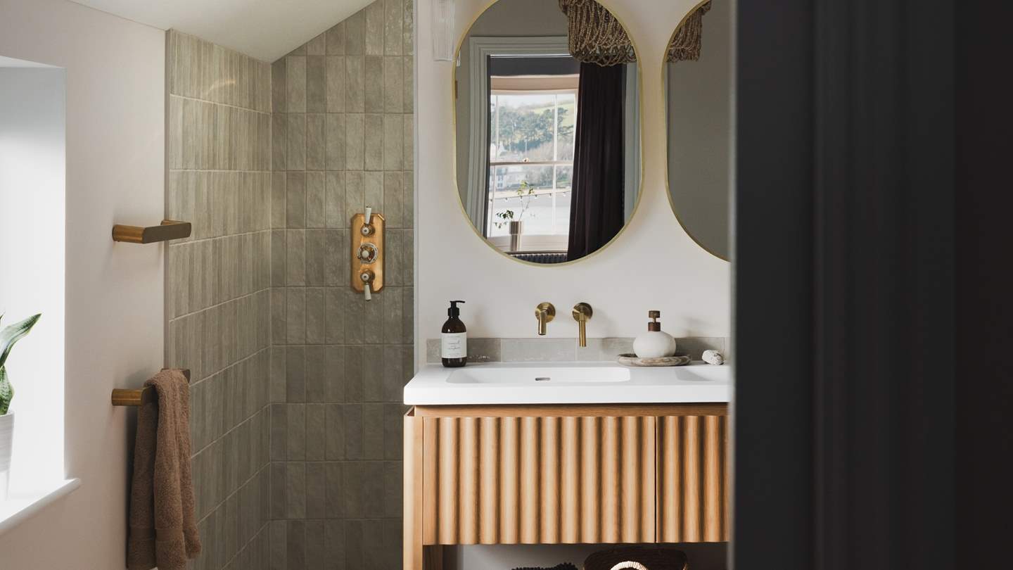 The ensuite features a double vanity unit, and a beautifully hidden rainfall shower