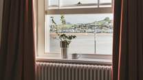A sea-view window reveals uninterrupted vistas overlooking the water towards the picturesque village of Instow