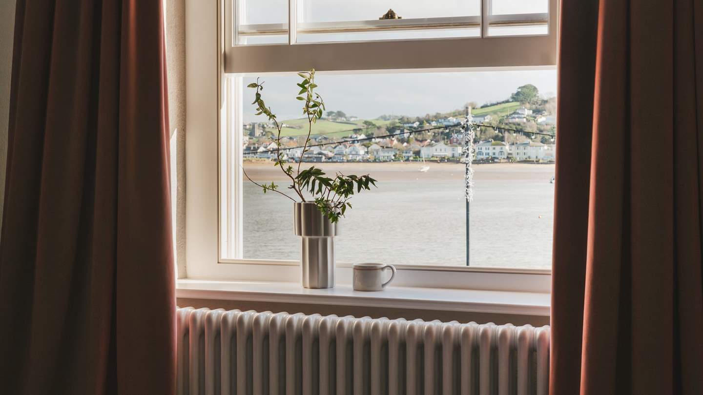 A sea-view window reveals uninterrupted vistas overlooking the water towards the picturesque village of Instow