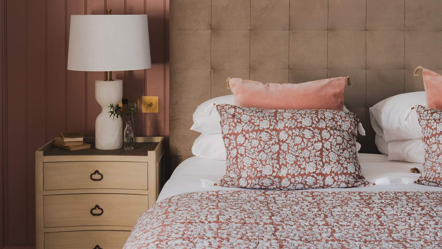 Beckoning for blissful repose, a super-king bed sits pretty, draped with the finest linens