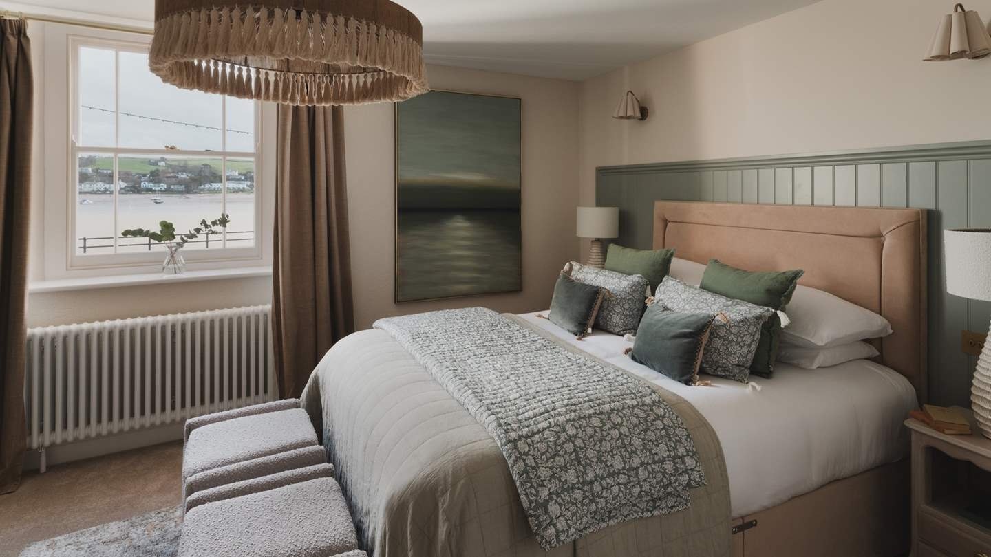 The second, bathed in forest tones, features a sumptuous king bed