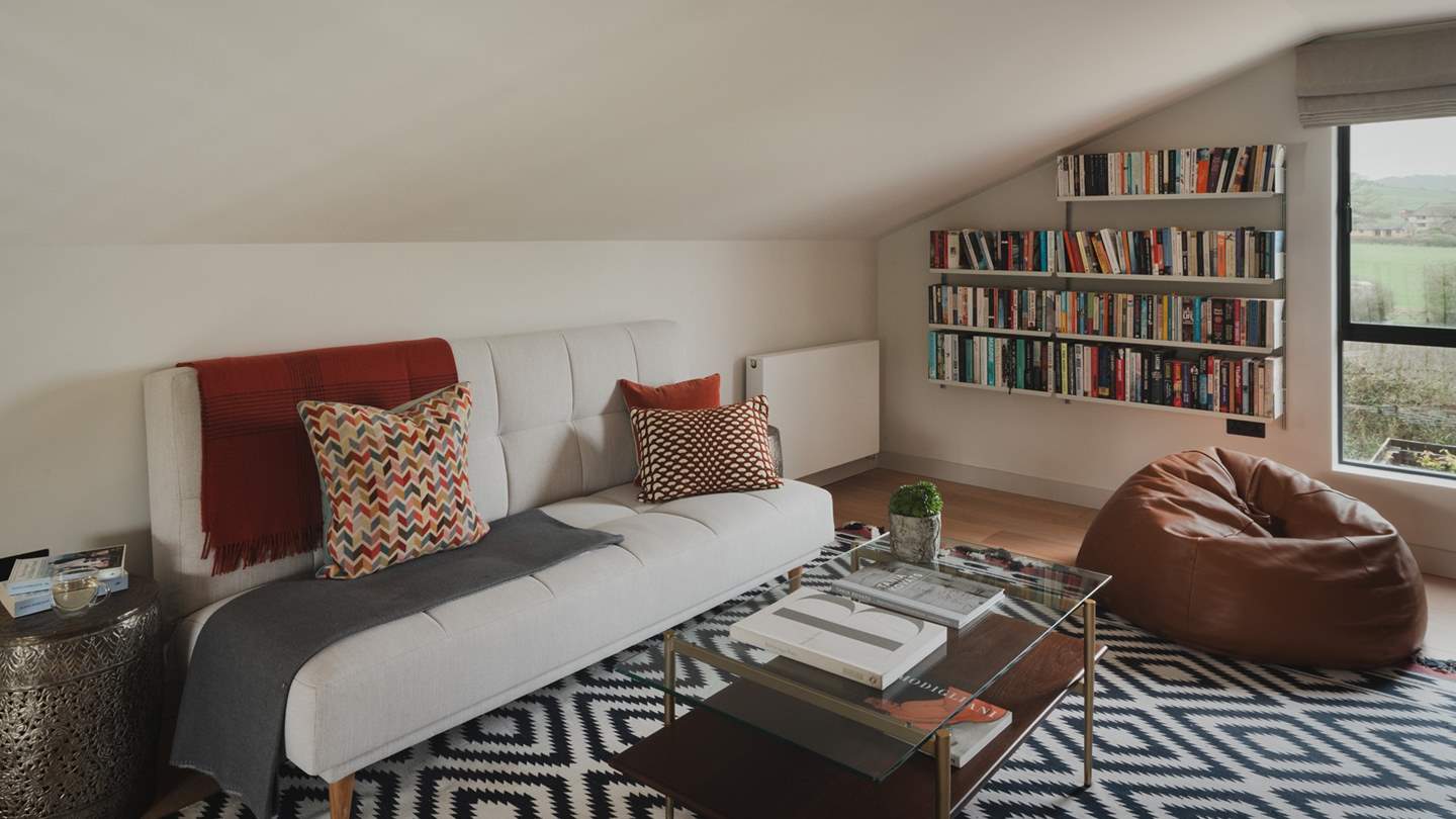 For those moments lost in page or film, a mezzanine floor features a cosy sofa, beanbag, Smart TV, and a large selection of books