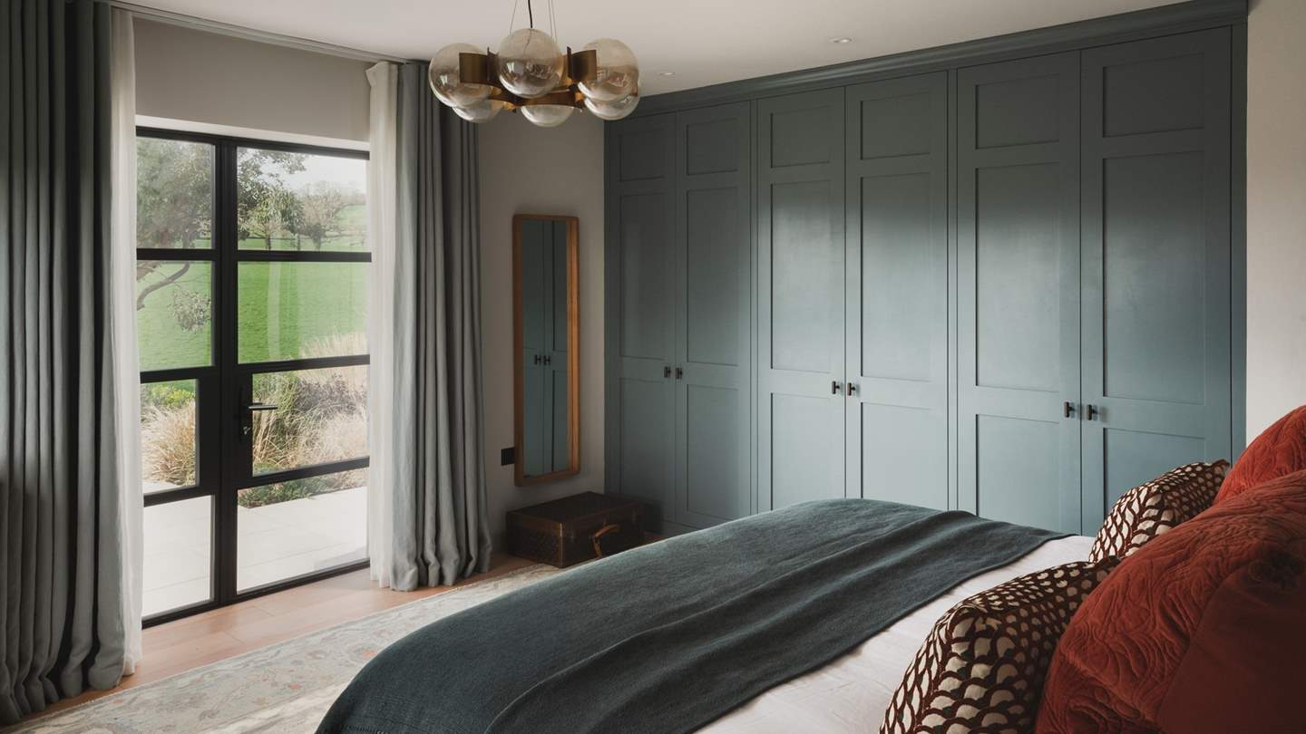 A super king bed swathed in the finest linens tempts for lingering lie-ins and enjoys dappled views across the garden