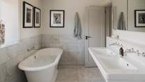 An ensuite bathroom with a bath and shower ensures utmost luxury and privacy