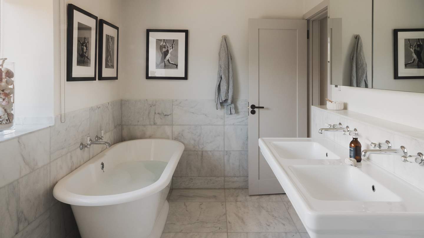 An ensuite bathroom with a bath and shower ensures utmost luxury and privacy