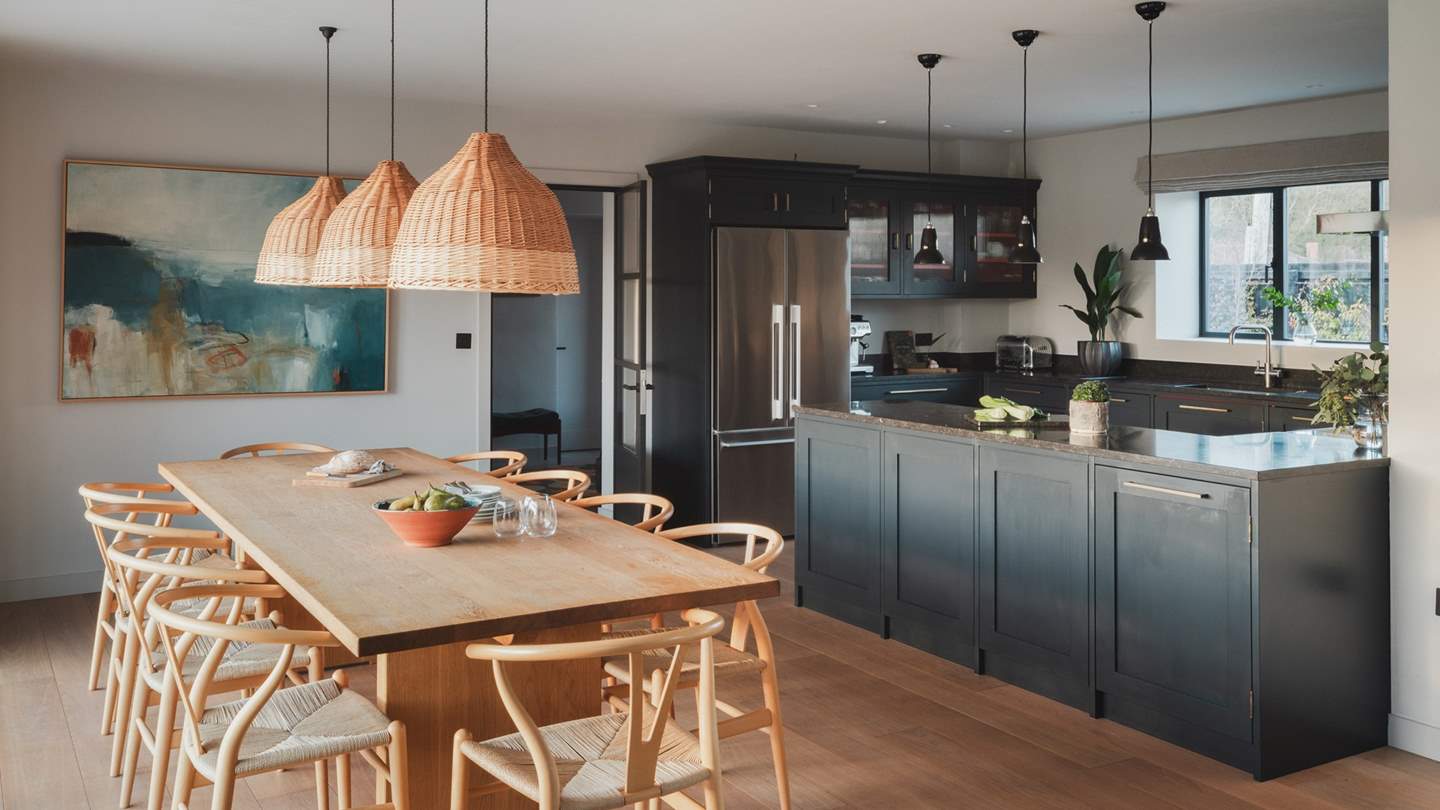 In a stunning open-plan design, the beautiful kitchen and dining areas enjoy a seamless flow 