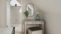 A dressing table and mirror provide a quiet space to get ready each day