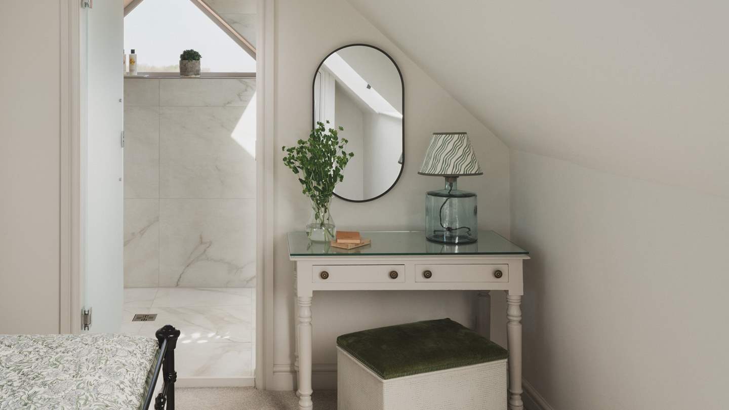 A dressing table and mirror provide a quiet space to get ready each day