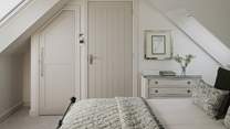For stowing belongings there’s a built-in wardrobe and chest of drawers
