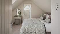 Offering flexible sleeping arrangements, the master bedroom features a super king zip-and-link bed