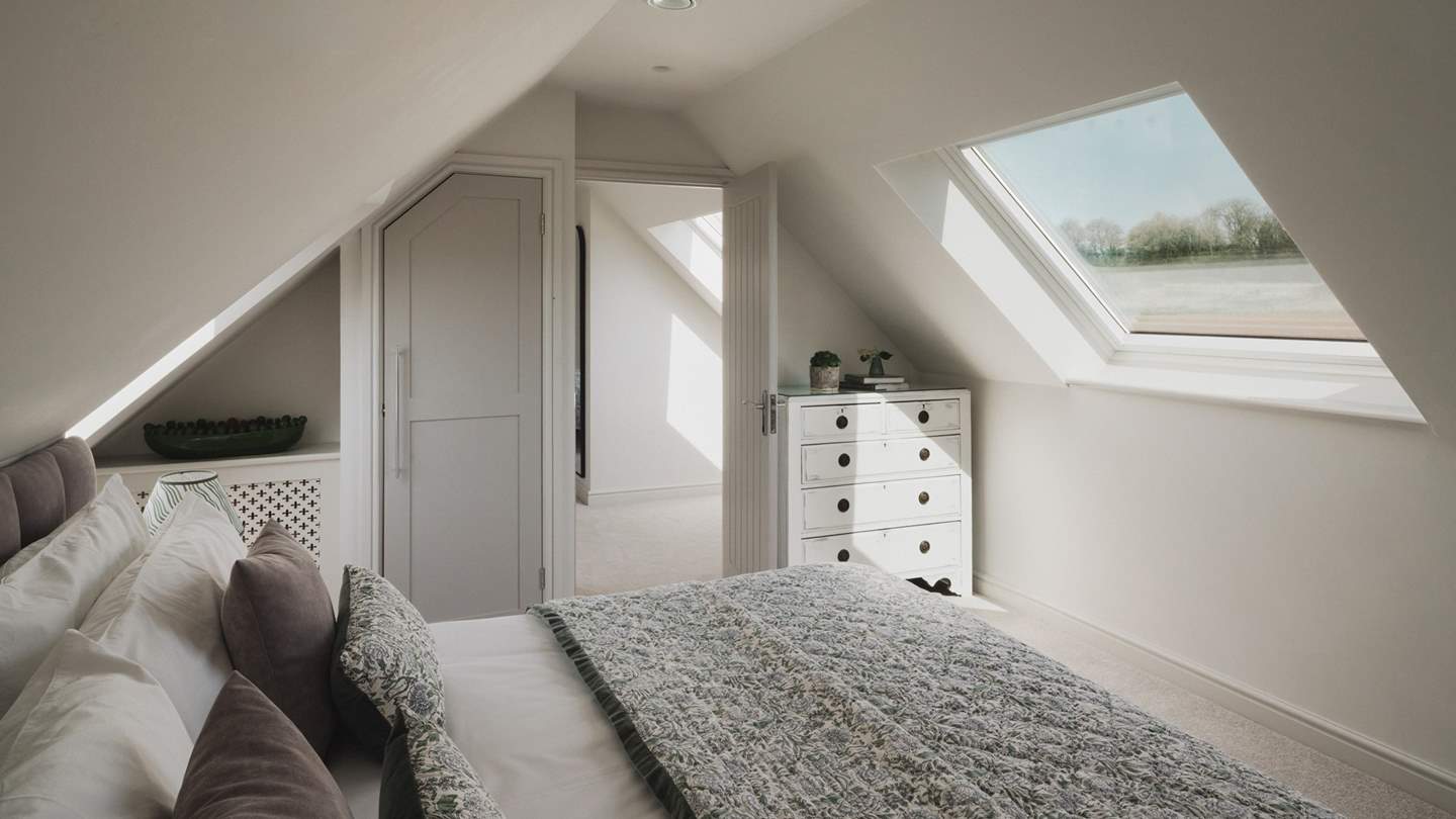 A chest of drawers and built-in wardrobe offer ample storage