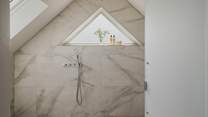 With a large rainfall shower at its centre and a separate handheld attachment, the ensuite wet room is a dream space for spa-like serenity