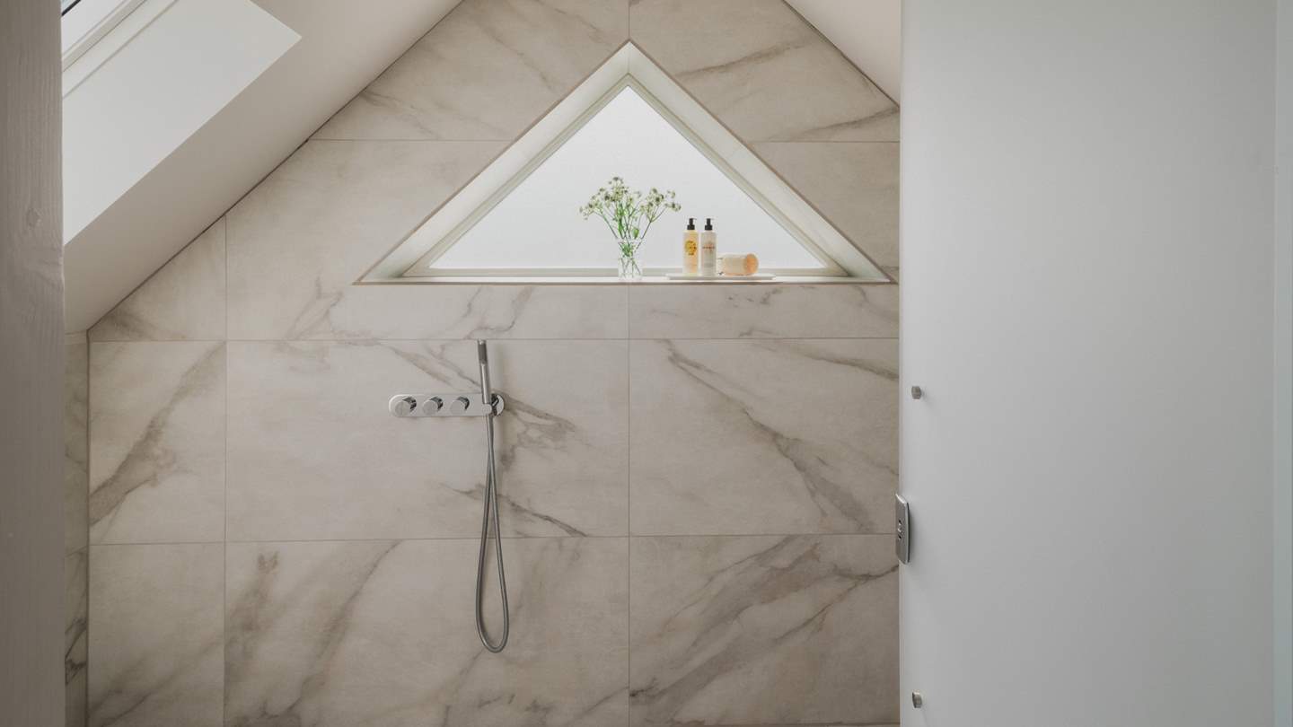 With a large rainfall shower at its centre and a separate handheld attachment, the ensuite wet room is a dream space for spa-like serenity