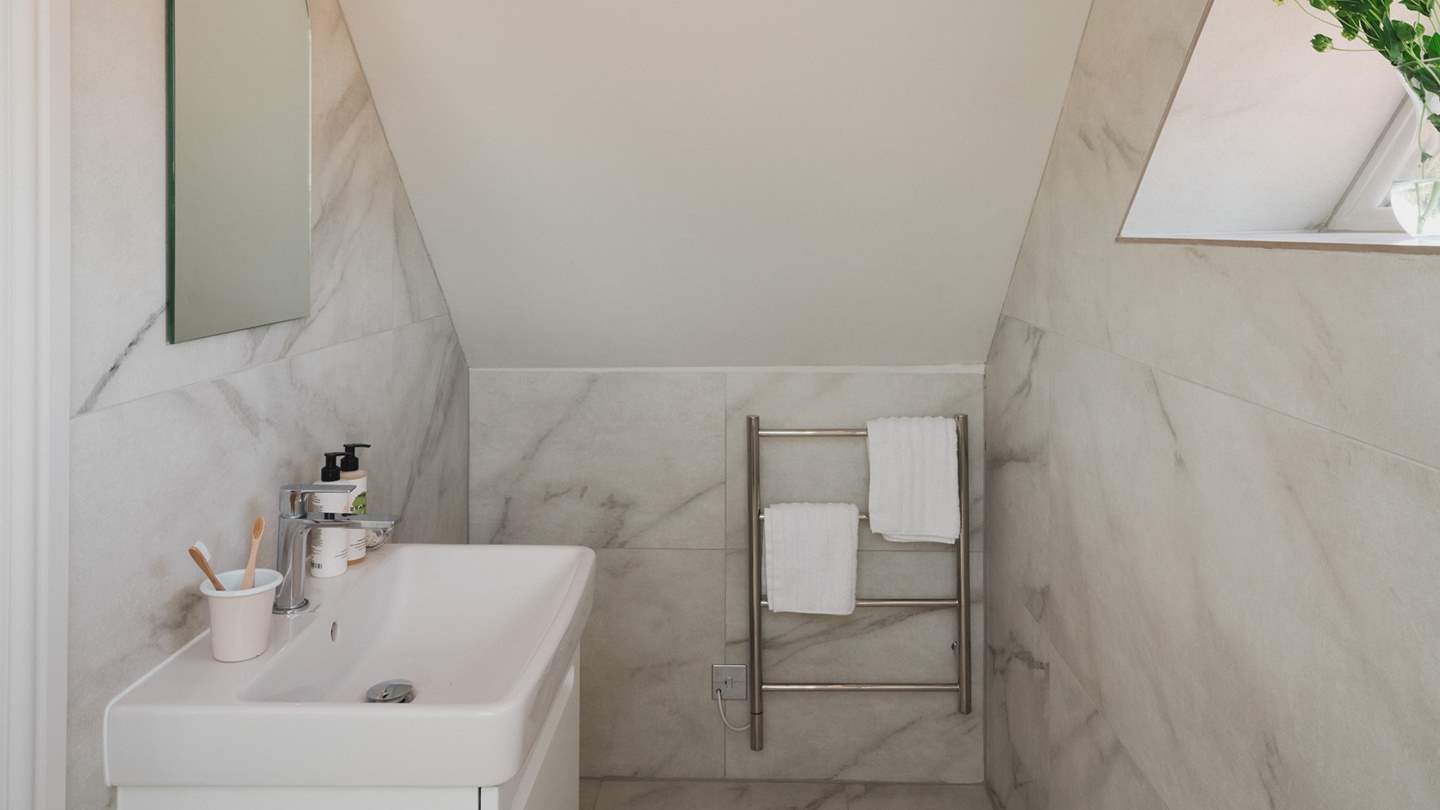 Complete with a large rainfall shower and separate handheld attachment, plus a heated towel rail