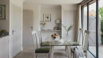 A writing desk can be found beside the dining table
