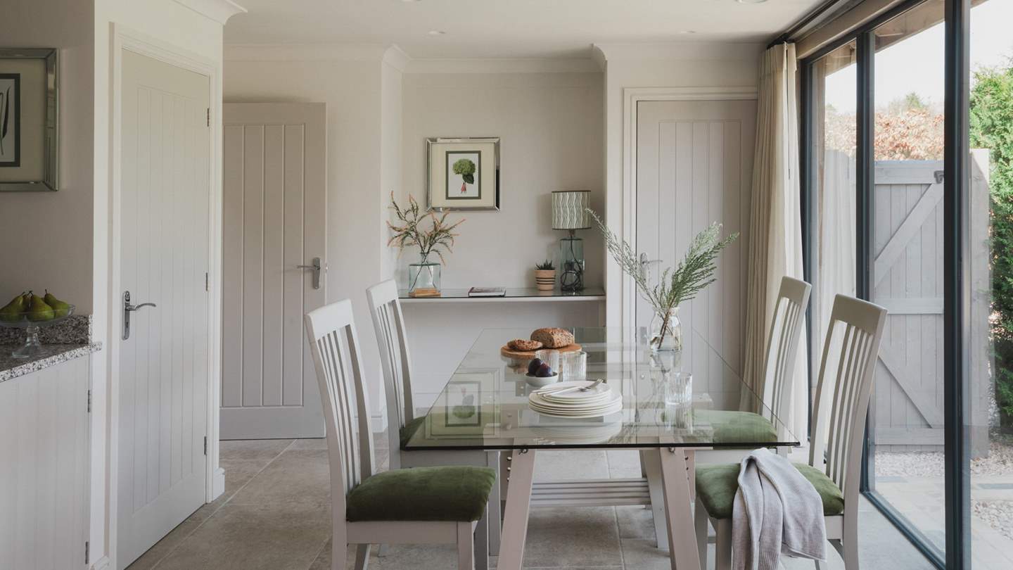 A writing desk can be found beside the dining table