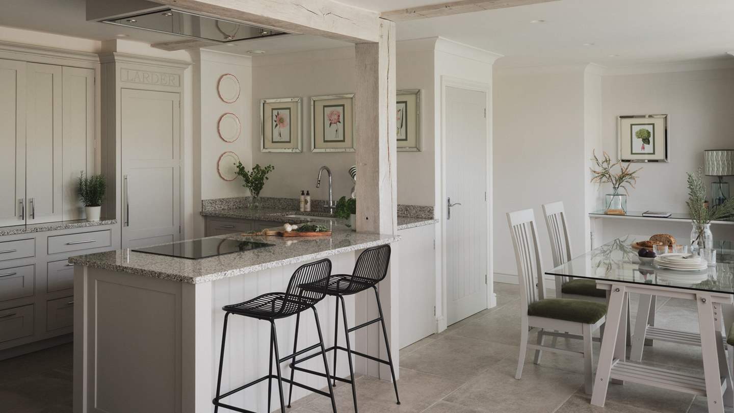 At the heart of the room, uncover a modern farmhouse style kitchen 