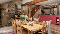 Exuding romantic rusticity with homely farmhouse styling, open beams, and exposed stonework, the kitchen space is a delight 