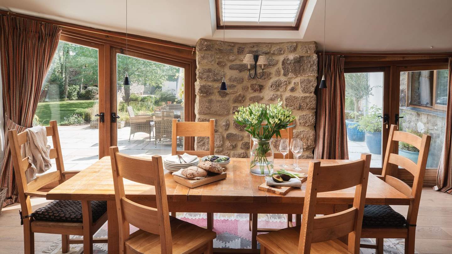 The kitchen features a farmhouse dining table