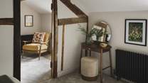 This room also features a dressing table and stool for morning rituals