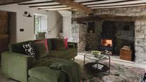 Eira’s Grade II listed, open-plan living space is home to a handsome wood burning stove set within a traditional inglenook fireplace