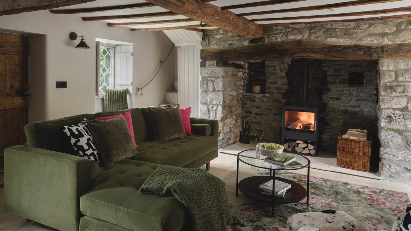 Eira’s Grade II listed, open-plan living space is home to a handsome wood burning stove set within a traditional inglenook fireplace